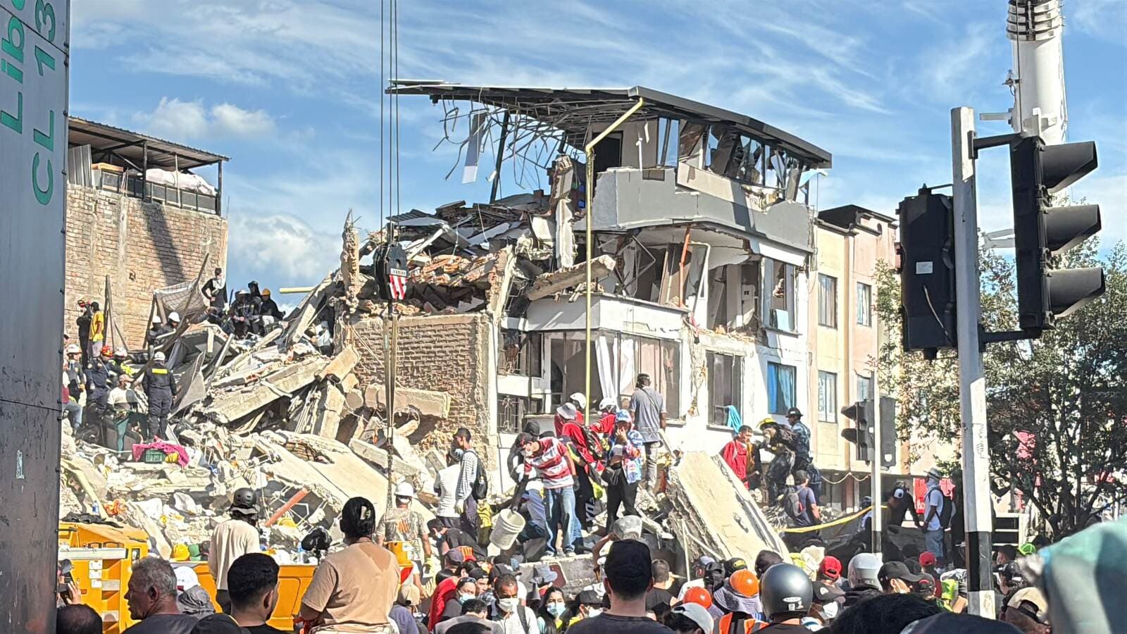 Rescuers and residents at a collapsed building in Pereira, Colombia, after the August 10 earthquake