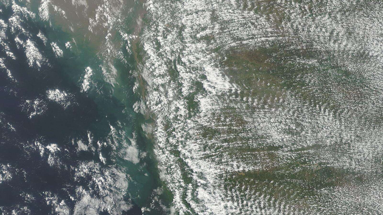 Satellite view of monsoon clouds and sediment-laden coastal waters along Maharashtra's Konkan coast, July 12, 2026